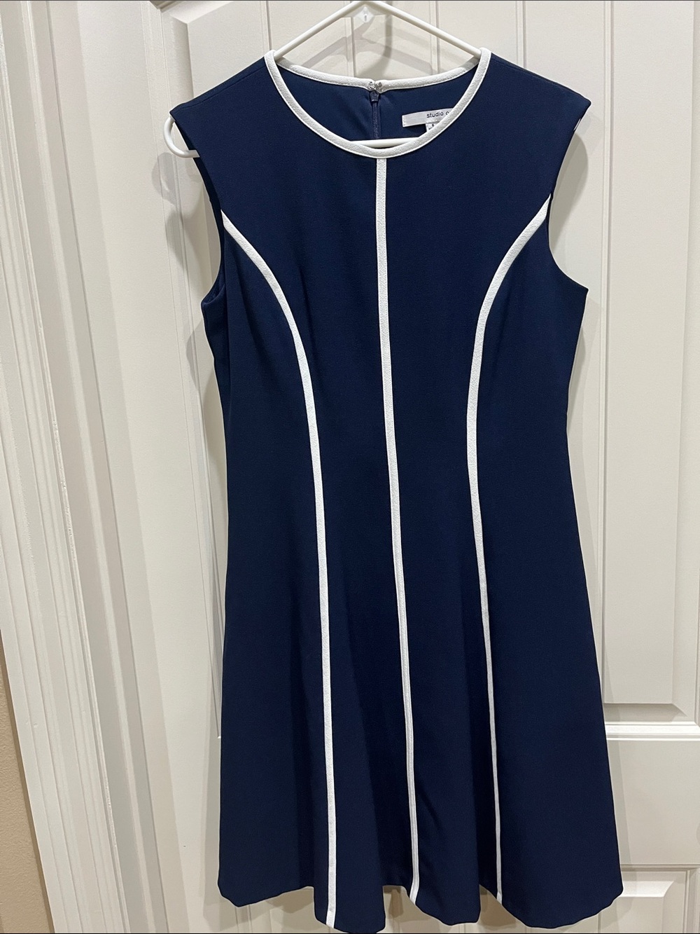 Sleeveless Navy Midi Dress with White Trim.